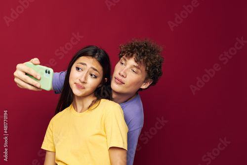 young man and girl take a selfie posing hug isolated background