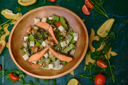 salad with vegetables and herbs and red fish