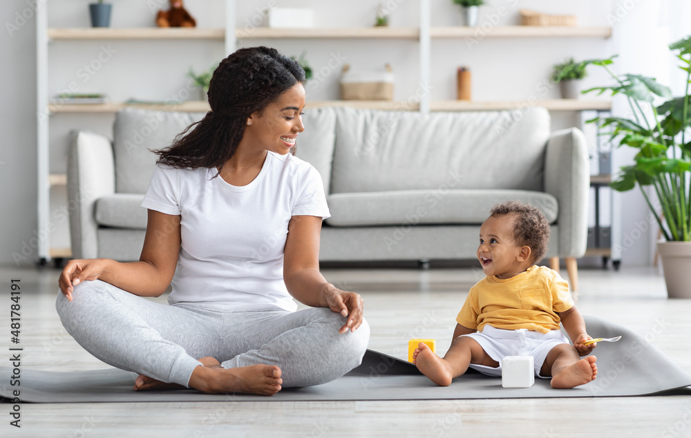 Yoga With Baby. Happy Black Mom And Infant Son Meditating At Home