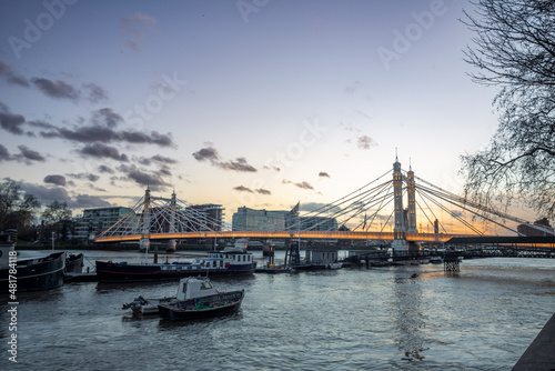 Albert Bridge, London Albert Bridge is a road bridge over the Tideway of the River Thames connecting Chelsea in Central London on the north, left bank to Battersea on the south