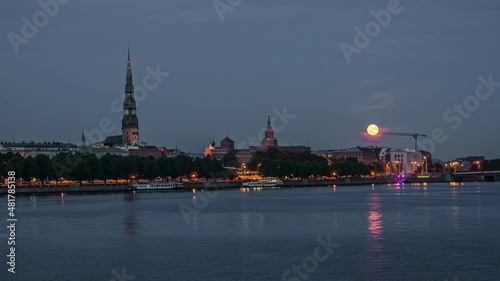 Historic Centre of Riga in Latvia in view from the Daugava River at moonrise in timelapse. photo