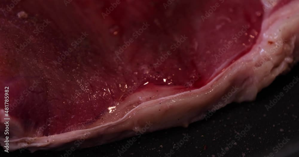 A timelapse of grilling T born stake meat on the pan in the kitchen close up
