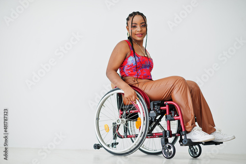 Tableau sur toile Young disabled African American woman in wheelchair against white wall