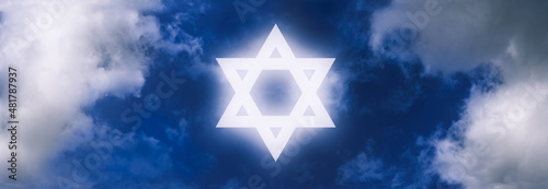 Star of David, symbol of Israel, shining on the sky amongst clouds. © To Studio