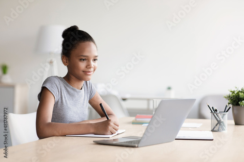 Pretty schoolgirl study, homework, online lesson at home, social distance, self-isolation, online education