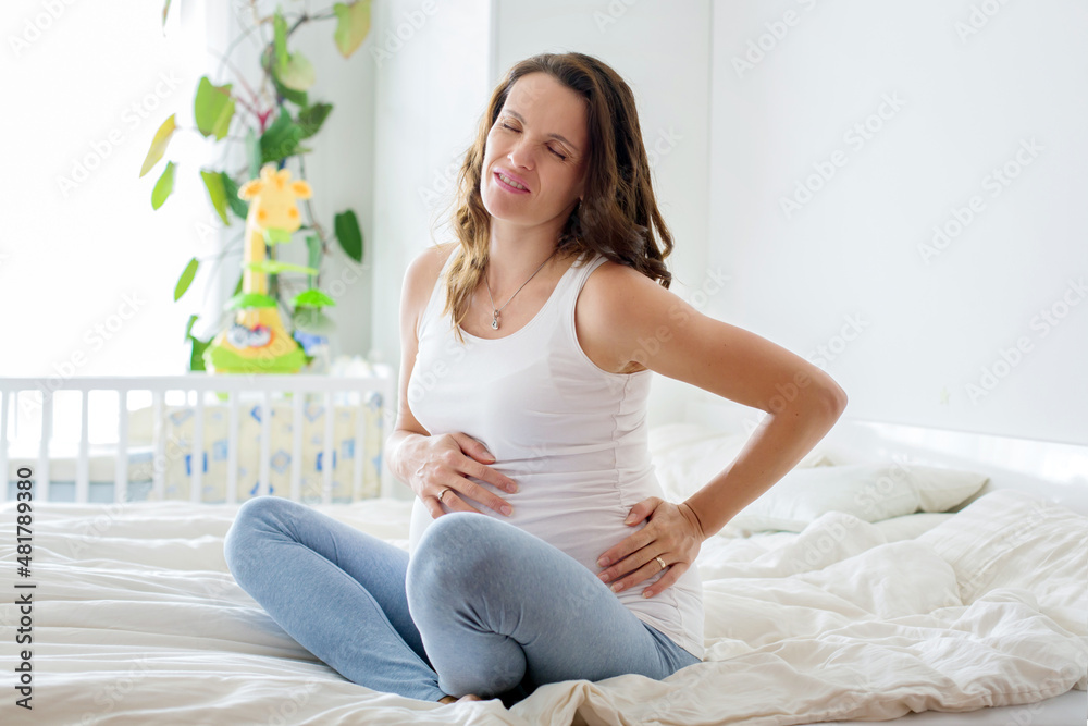 Young beautiful pregnant woman, in pain with labor contraction Young beautiful pregnant woman, in pain with labor contraction