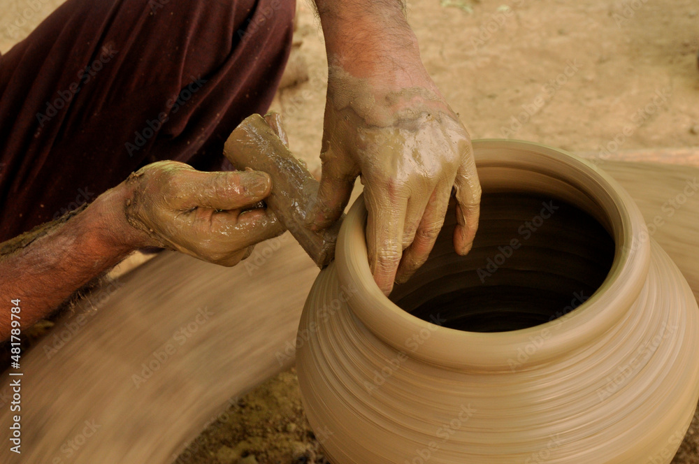 An Indian Artisan hands making clay pots 
