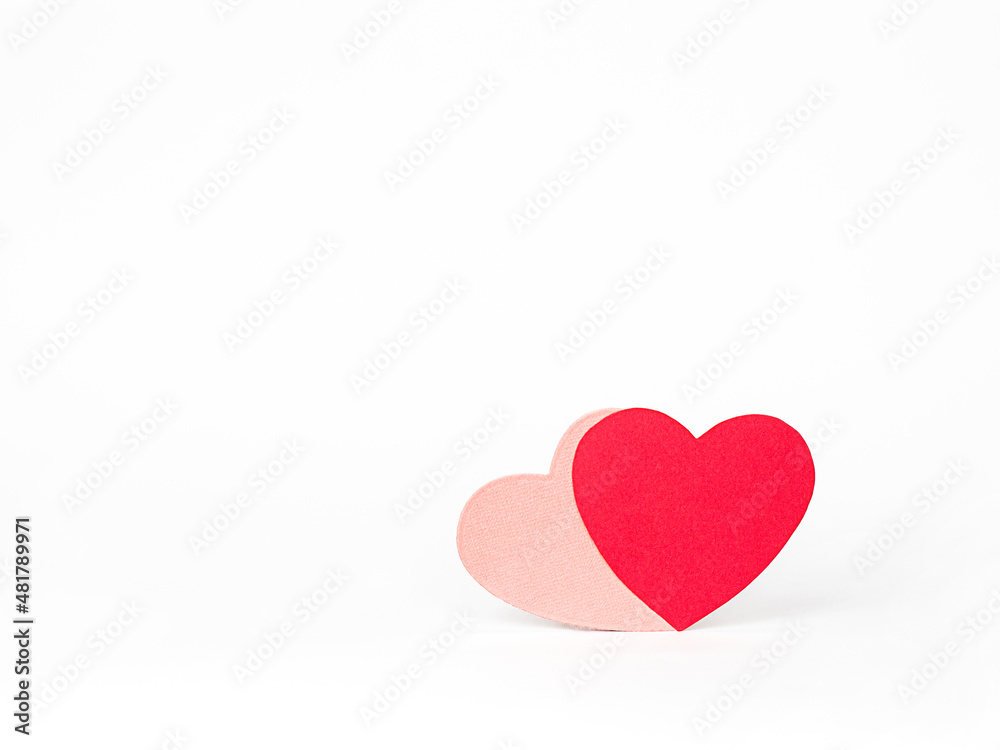 two paper hearts on a white background