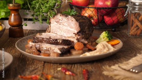 Whole roast pork neck. Zooming the camera to the dish.
