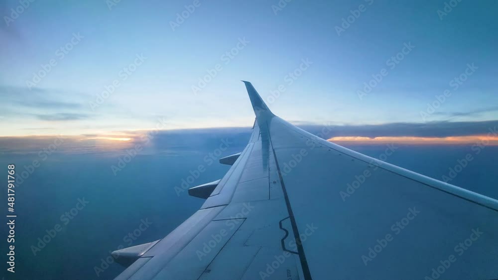 Airplane Wing, Clouds, And Sky Seen From Window During The Flight - static, POV Airplane Wing, Clouds, And Sky Seen From Window During The Flight - static, POV