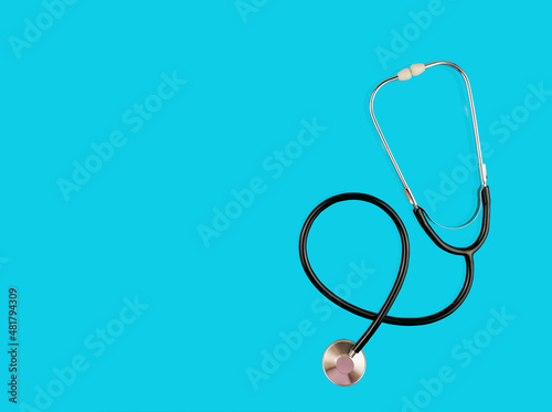 Phonendoscope on color background. Medical instrument on light blue background. Medicine concept. Flat lay
