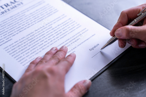 business man reading and signing a business contract, business agreement consensus signing, business concept and signing