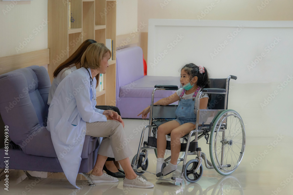 Medical care and healthcare concept. doctor service to young kid patient on wheelchair in hospital. 