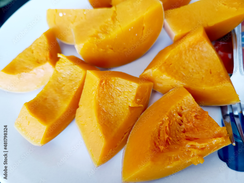 Close up butternut squash slice on white plate background.