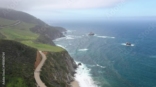 Car Driving At Bixby Creek Bridge Overlooking the Blue Seascape Of Big Sur In California, USA. - aerial