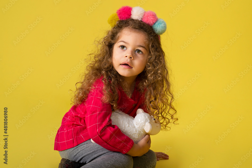 Cute girl kid holding money box in  bank for future saving