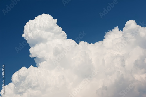Rising white cumulus clouds in blue sky