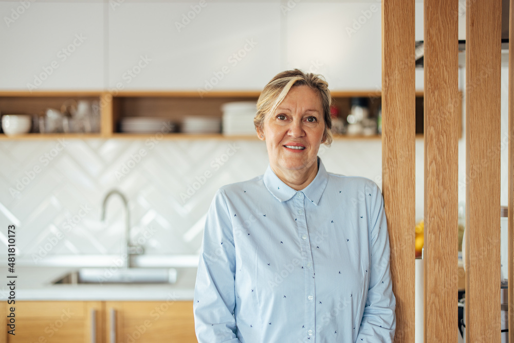 Portrait of happy caucasian woman, preparing to go into the kitchen to cook. Portrait of happy caucasian woman, preparing to go into the kitchen to cook.
