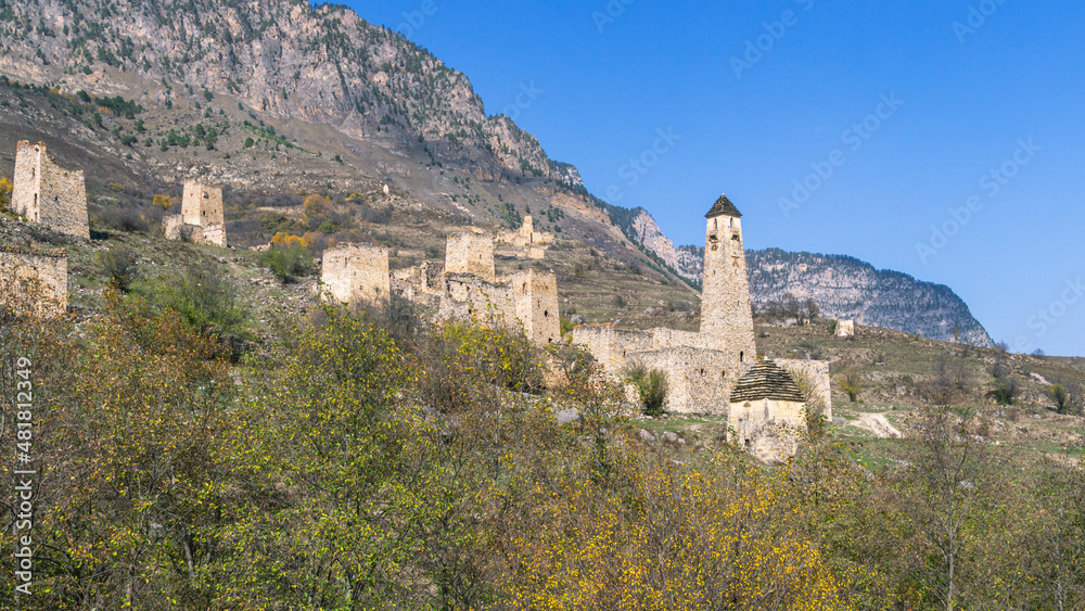 An abandoned medieval town. A complex of towers in the mountains of Ingushetia. Military and residential ancient towers built of stones. Landscape in the mountains with a view of the ruins. 