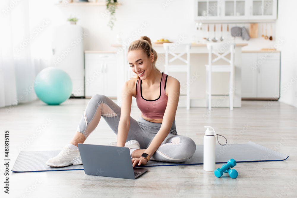 Φωτογραφία Smiling caucasian cute young blonde fitness blogger woman looking at laptop, cha