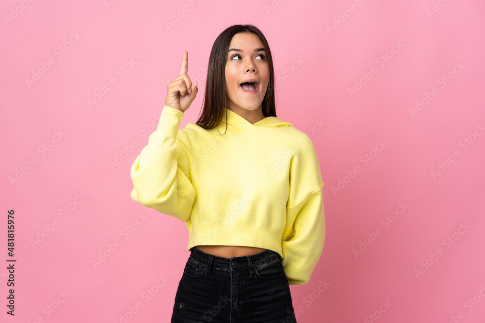 Teenager girl isolated on pink background intending to realizes the solution while lifting a finger up Teenager girl isolated on pink background intending to realizes the solution while lifting a finger up