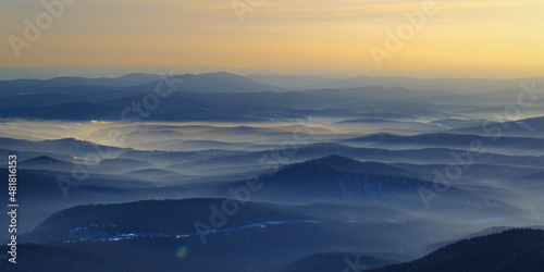 Colorful mountain hills with tonal perspective at winter evening at sunset. Abstract panoramic landscape in Gornaya Shoria, Sheregesh ski resort in Russia Foggy Mountains nature environment