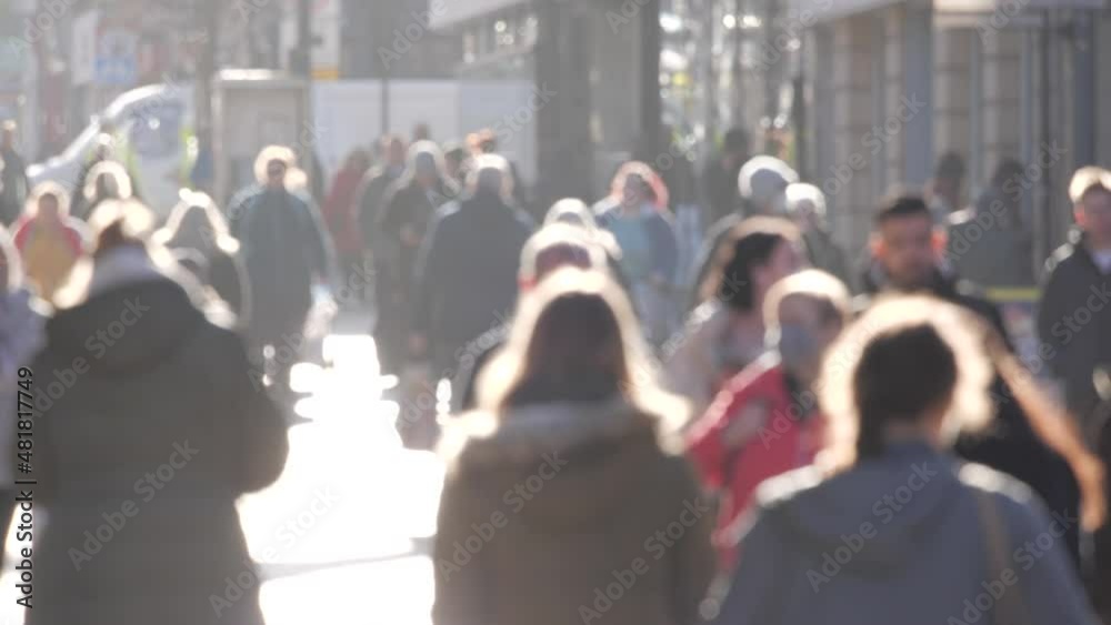 4K: Anonymous / Unrecognisable People walking in the city. Backlit men and women on the high street. Blurred. Slow motion. 