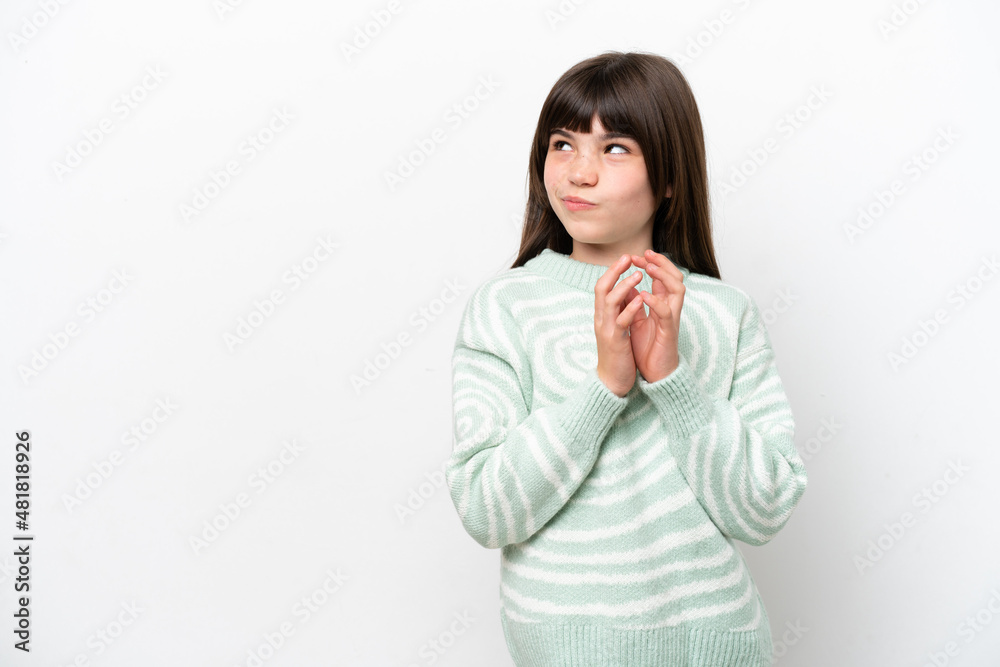 Little caucasian girl isolated on white background scheming something Little caucasian girl isolated on white background scheming something