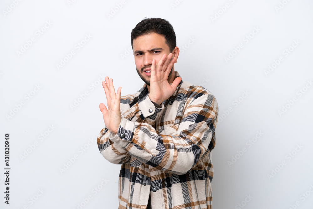 Young Brazilian man isolated on white background nervous stretching hands to the front Young Brazilian man isolated on white background nervous stretching hands to the front
