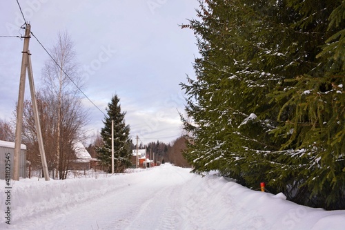 Winter snowy road in the village.