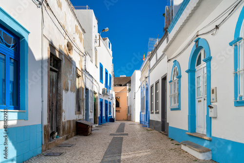 white and blue houses typical of the fishing village of Olhao, Algarve, Portugal. © Armando Oliveira