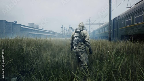 Post apocalyptic atmosphere with a lone survivor man and a train going nowhere. A man surviving a nuclear apocalypse. The looped animation is ideal for sci-fi, military and apocalyptic backgrounds. photo