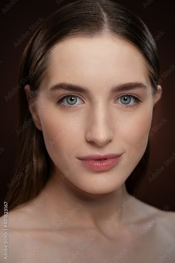 Fototapeta premium Natural beauty woman with no make up face portrait. Healthy pure skin model posing on camera isolated on black background. Natural make up concept. Spa and beautiful concept