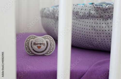 Detail of nice dummy in child cot