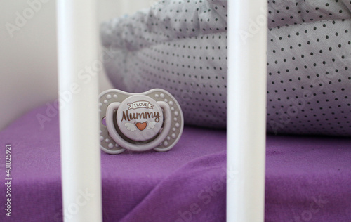 Detail of nice dummy in child cot