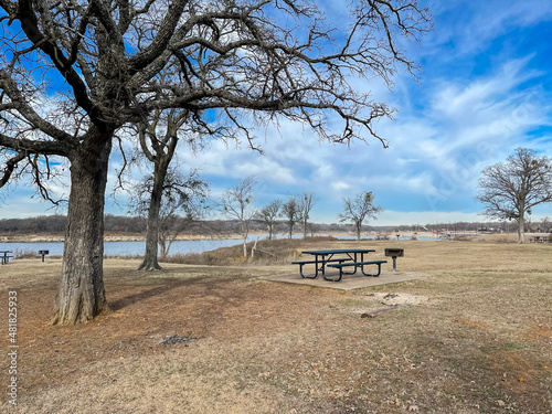 Beautiful lakeside picnic area with tables and fire pits at Murrell Park along North side of Grapevine Lake in Texas  America