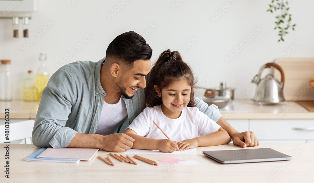 Loving single father and daughter painting together, kitchen interior Loving single father and daughter painting together, kitchen interior