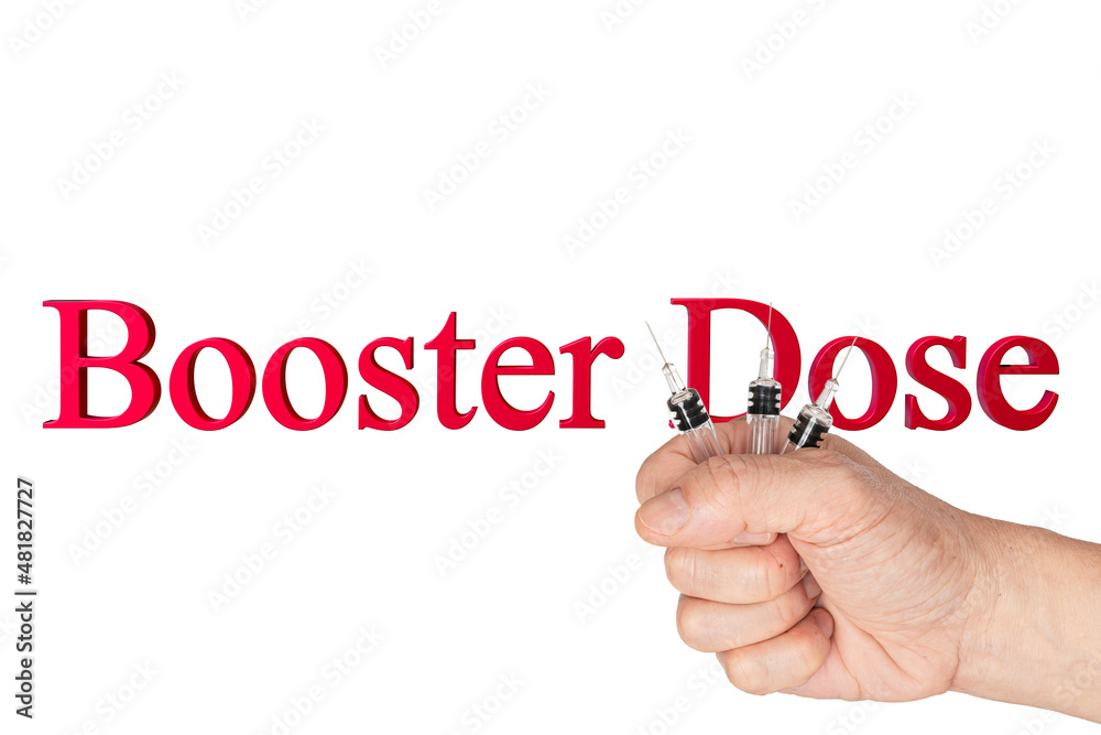 A hand holding glass syringes with a text booster dose on white background. A hand holding glass syringes with a text booster dose on white background.