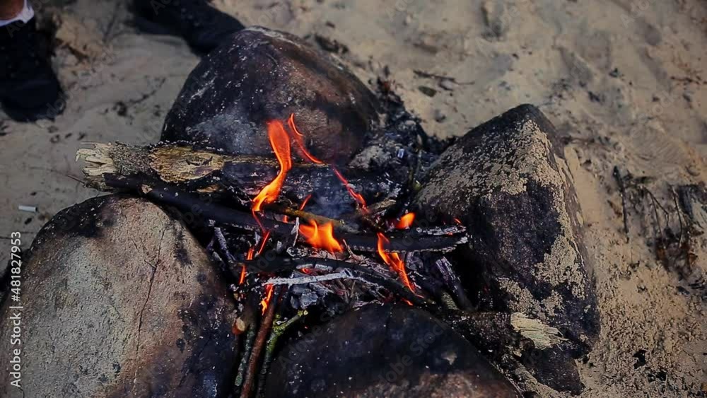small fire burning surrounded by pebbles small fire burning surrounded by pebbles