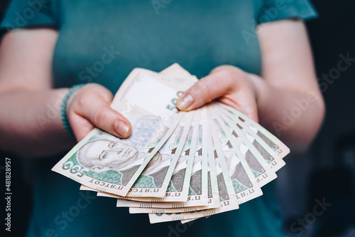 a person holds in his hands banknotes of the Ukrainian currency of 500 hryvnias