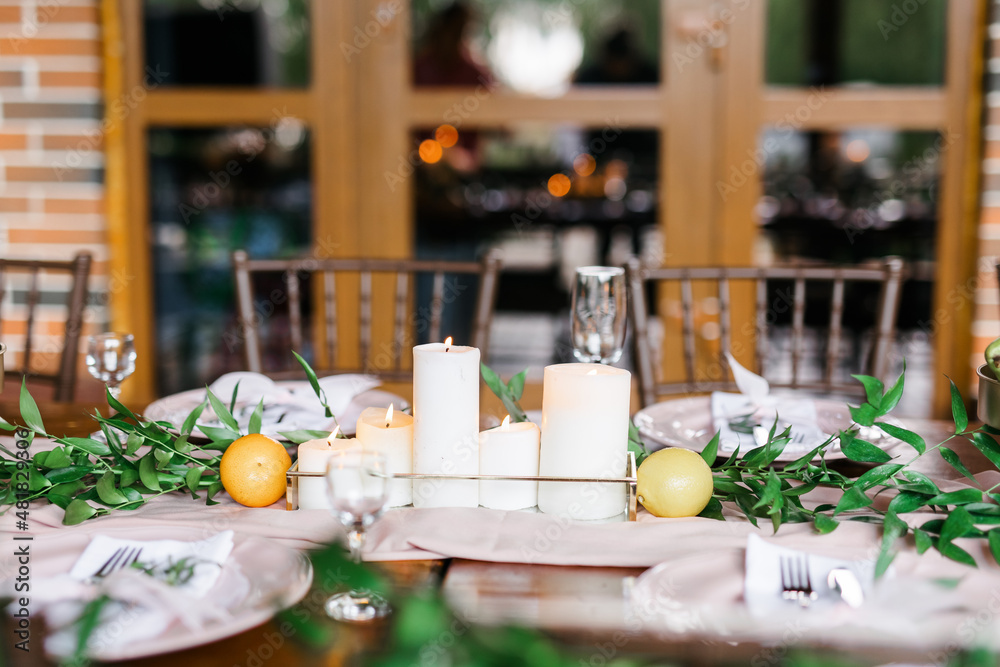 A beautiful outdoor wedding setting in pink flowers. Floral arrangements of white and pink fresh flowers. Lots of candles for dinner. 