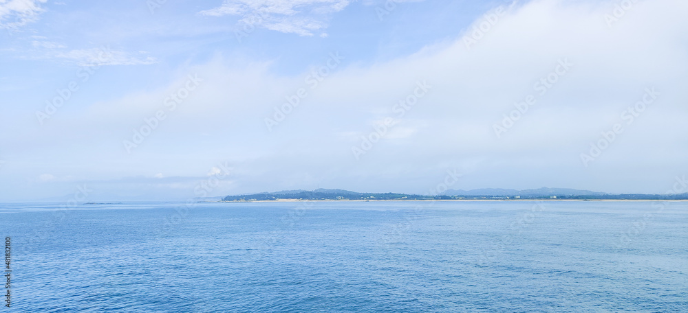 blue sea and sky with white clouds