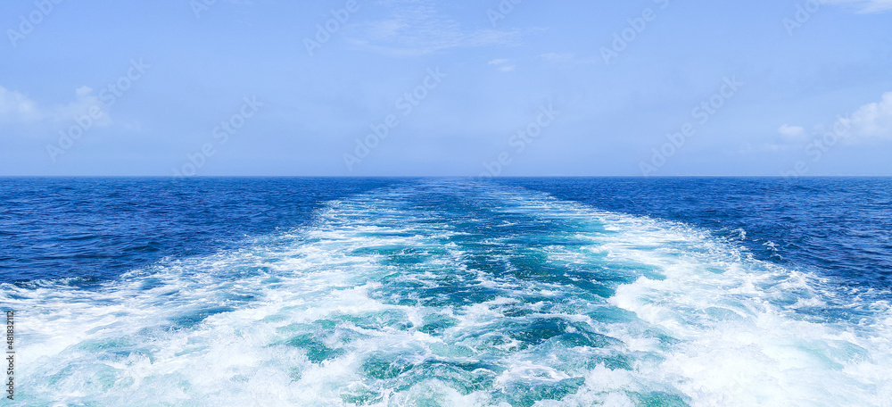 Trail on water surface behind of fast moving or sailing ship or boat Trail on water surface behind of fast moving or sailing ship or boat