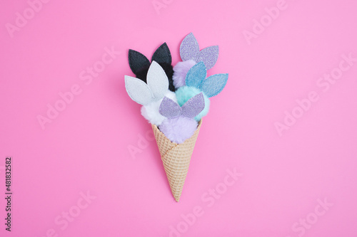 Ice Cream cone with cute fluffy bunnies. Minimal Easter concept. Flat lay.