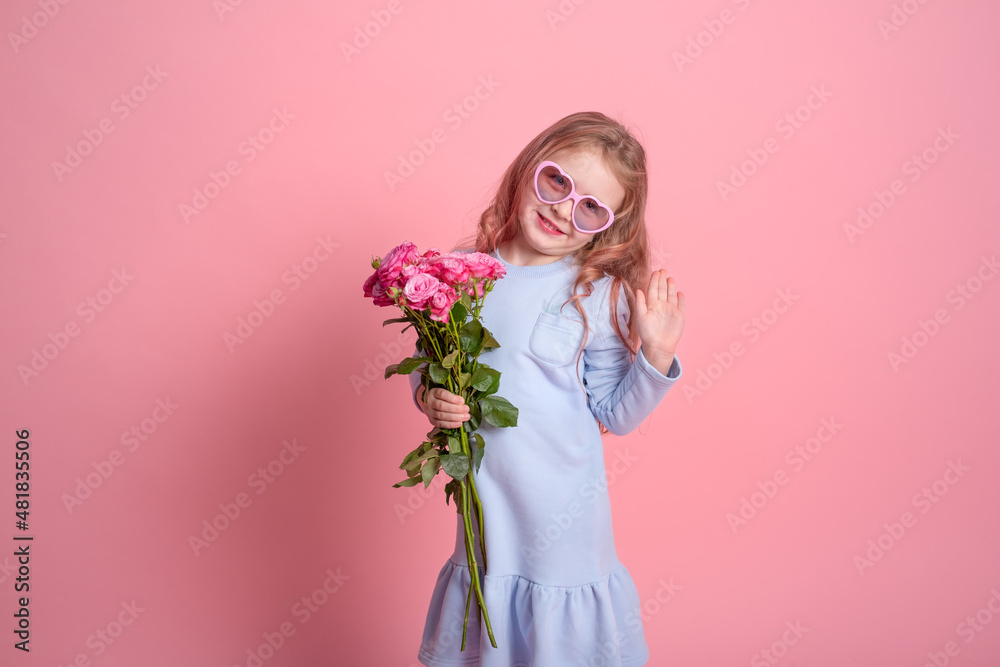 cute child girl in blue dress and sunglasses holding bouquet of pink roses on pink background cute child girl in blue dress and sunglasses holding bouquet of pink roses on pink background