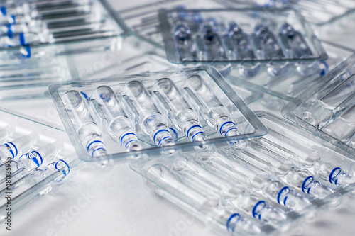 plastic transparent containers with glass ampoules on a white background