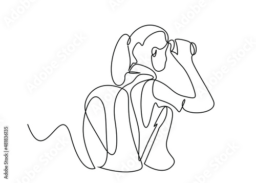 woman with bag looking forward with binoculars in nature