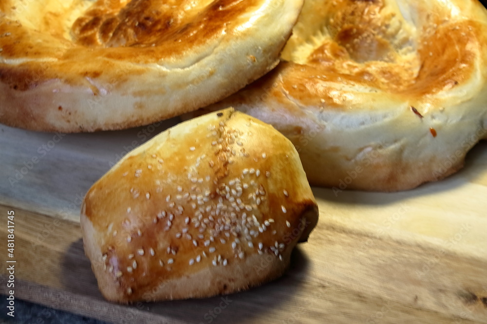 An asian samsa with beef filling and a couple of loaves of asian bred An asian samsa with beef filling and a couple of loaves of asian bred