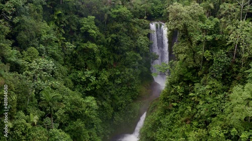 Relaxing nature background: approaching a stunning waterfall inside a tropical forest