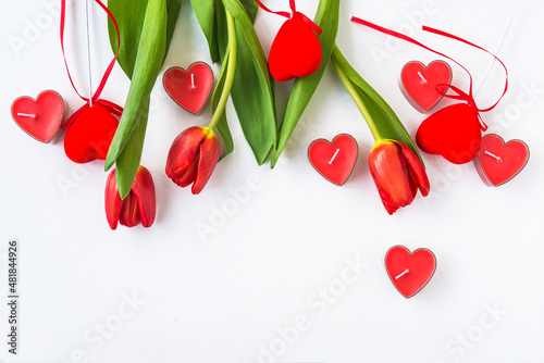 Valentine s day greeting card  Red tulips and candles shape heart on white background  space for text